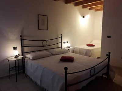 Letto o letti in una camera di LA TANA DEL PICCHIO