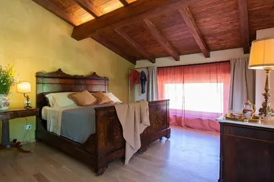Letto o letti in una camera di Relais SANT'AMBROGIO