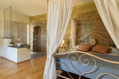 Letto o letti in una camera di Relais SANT'AMBROGIO