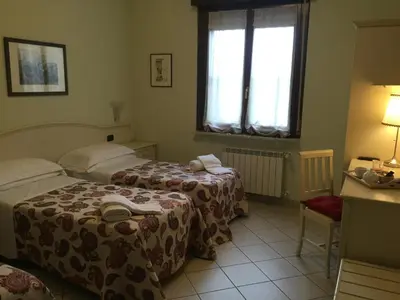 Letto o letti in una camera di Albergo Il Gufo