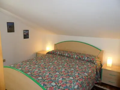 Letto o letti in una camera di MANSARDA PARADISO GOLFO DI PORTOFINO