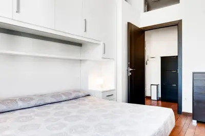 Letto o letti in una camera di GuestHost - Migliarina Cozy Apartment