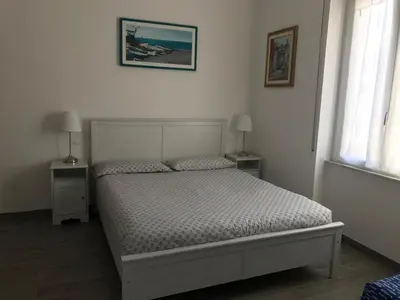 Letto o letti in una camera di HOST IN LEVANTO - Maestrale con biciclette