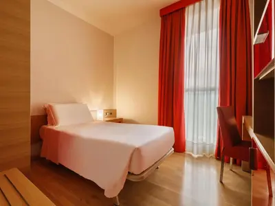 Letto o letti in una camera di B&B HOTEL Remilia