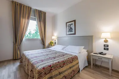 Letto o letti in una camera di Hotel Michelangelo