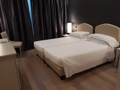 Letto o letti in una camera di Grand Hotel De La Ville