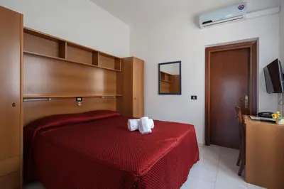 Letto o letti in una camera di Hotel Nella