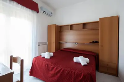 Letto o letti in una camera di Hotel Nella