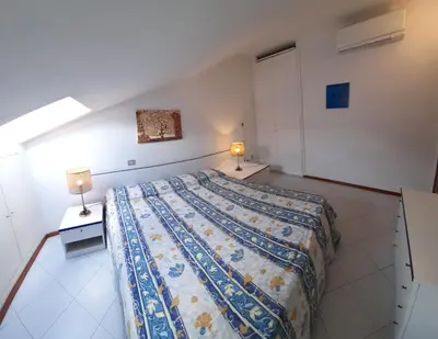Letto o letti in una camera di Attico del sole zero undici zero uno sette lt 0787