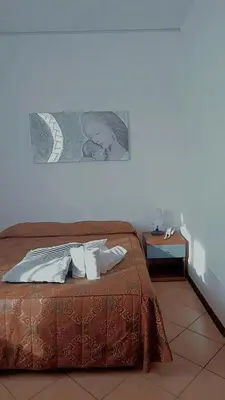 Letto o letti in una camera di albergo del turista srl