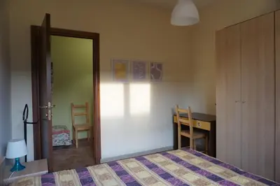 Letto o letti in una camera di Appartamento con Giardino