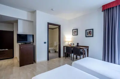 Letto o letti in una camera di Stadio Hotel