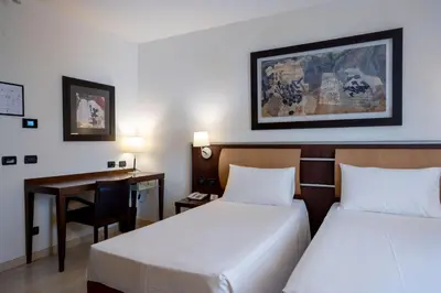 Letto o letti in una camera di Stadio Hotel