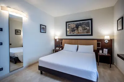Letto o letti in una camera di Stadio Hotel