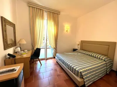 Letto o letti in una camera di Hotel Clelia