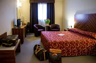 Letto o letti in una camera di MH Hotel Piacenza Fiera