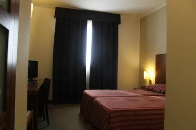 Letto o letti in una camera di MH Hotel Piacenza Fiera