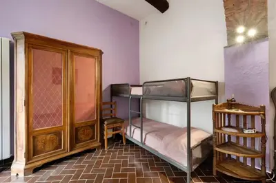 Letto o letti in una camera di VECCHIO MULINO FONTONA Ortensia
