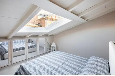 Letto o letti in una camera di HOUSE Cavour 24 In the heart of Downtown Parma