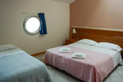 Letto o letti in una camera di Albergo Meublè Abatjour