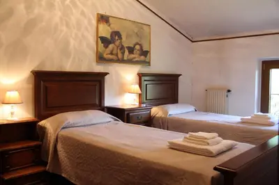 Letto o letti in una camera di Villa Veralda, la magia di una Toscana insolita