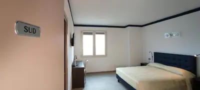 Letto o letti in una camera di Suites Direzionale Carpi