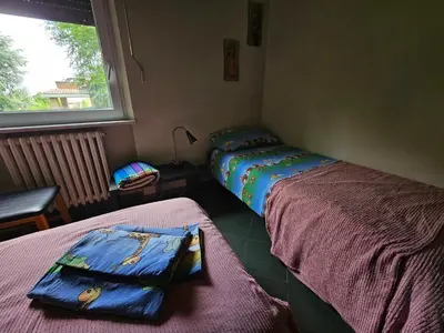 Letto o letti in una camera di Casa VINCENZO 130 mq con portico ed ingresso esclusivo dal giardino