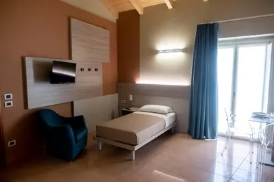 Letto o letti in una camera di CallMe Crema - Struttura in centro storico