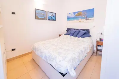 Letto o letti in una camera di 113 - Casa Le Terrazze in centro 100 metri Mare Spiaggia, BOX AUTO GRATIS
