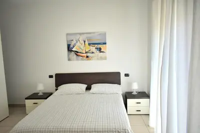 Letto o letti in una camera di bilocale Rachele