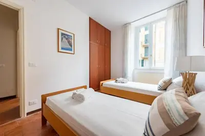 Letto o letti in una camera di WELCOME RIVIERA, Casa Luigina apartment, 90 sqm, sea view, 2 bedroom, 1 bathroom, free wifi, and, depending on availability, a private garage 800 meters away at 20,00 euro per night